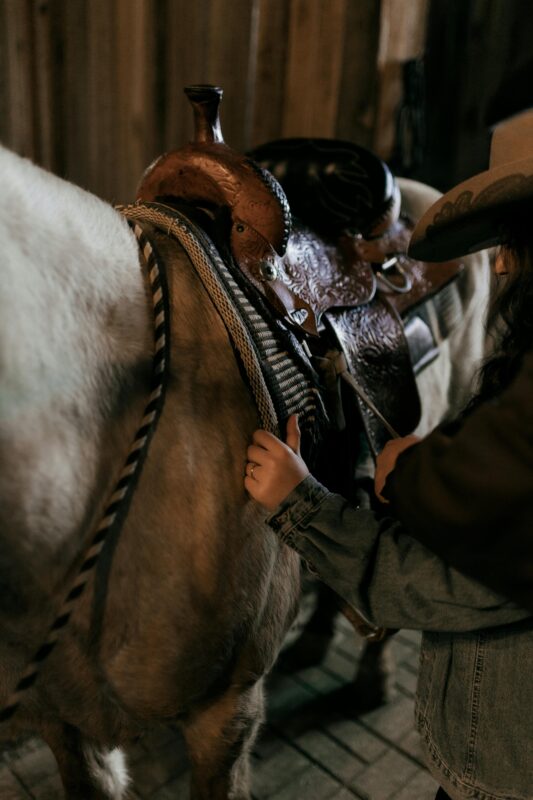 Barrel racing rider using a western saddle during a fast turn